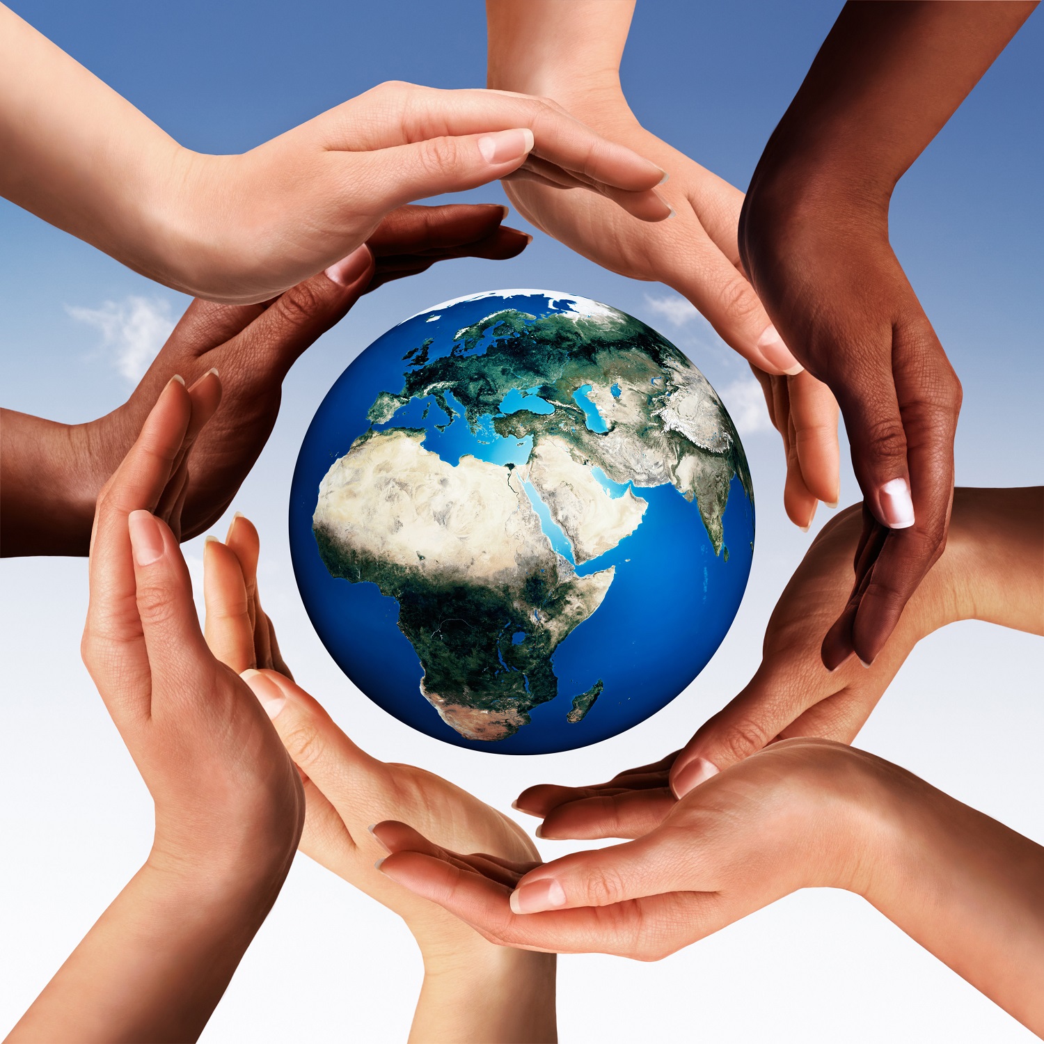 Multiracial hands making a circle together around the world glob Multiracial hands making a circle together around the world glob